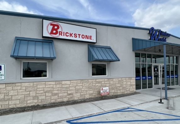 Image of a commercial building with signs for Brickstone and Window World