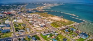 Aerial shot of a seaside city with a harbor, residential areas, and piers extending into the water