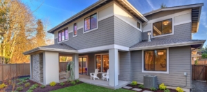 Modern home exterior with gray siding and landscaping