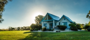 Small coastal-style home with large grassy yard